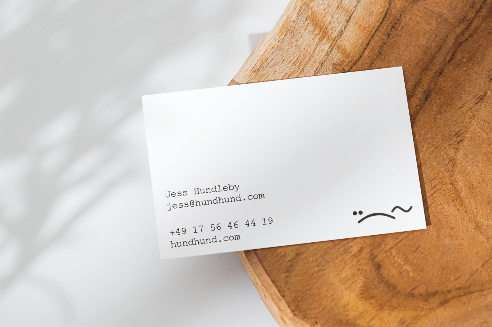 Hund & Hund business card sitting on natural wood base, design by BusbyWebb