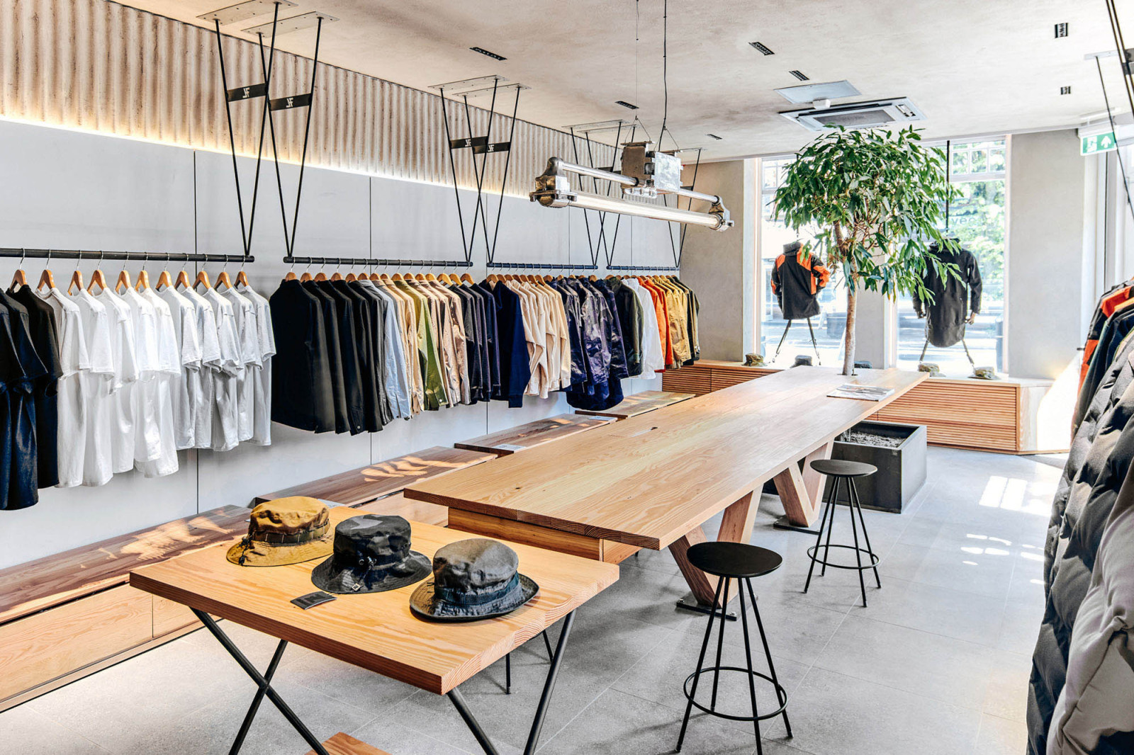 Seven Layer flagship store interior — social retail concept with nature-inspired materials and layered display architecture, designed by BusbyWebb