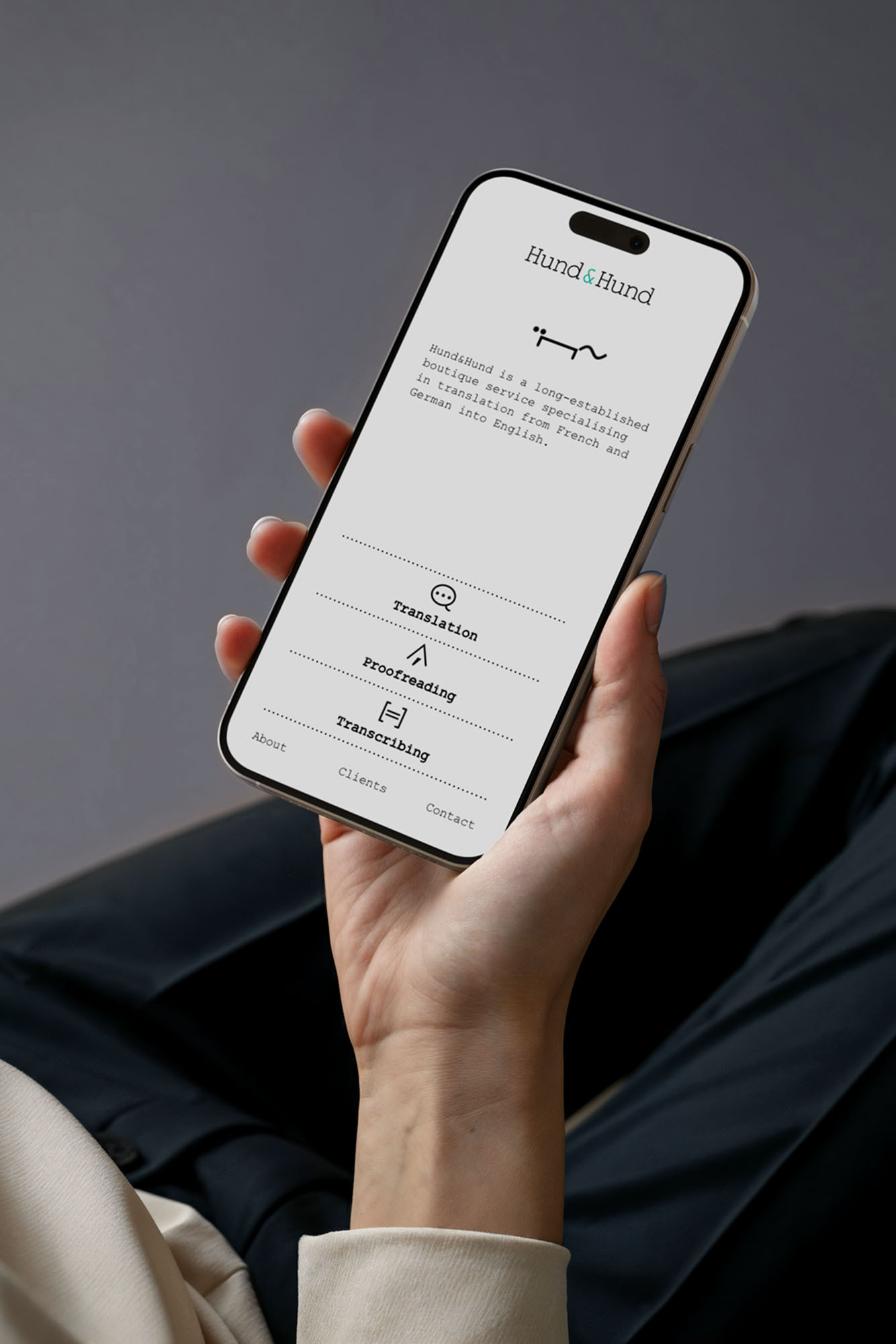 Hund & Hund mobile website displayed on  iPhone being held by woman by BusbyWebb