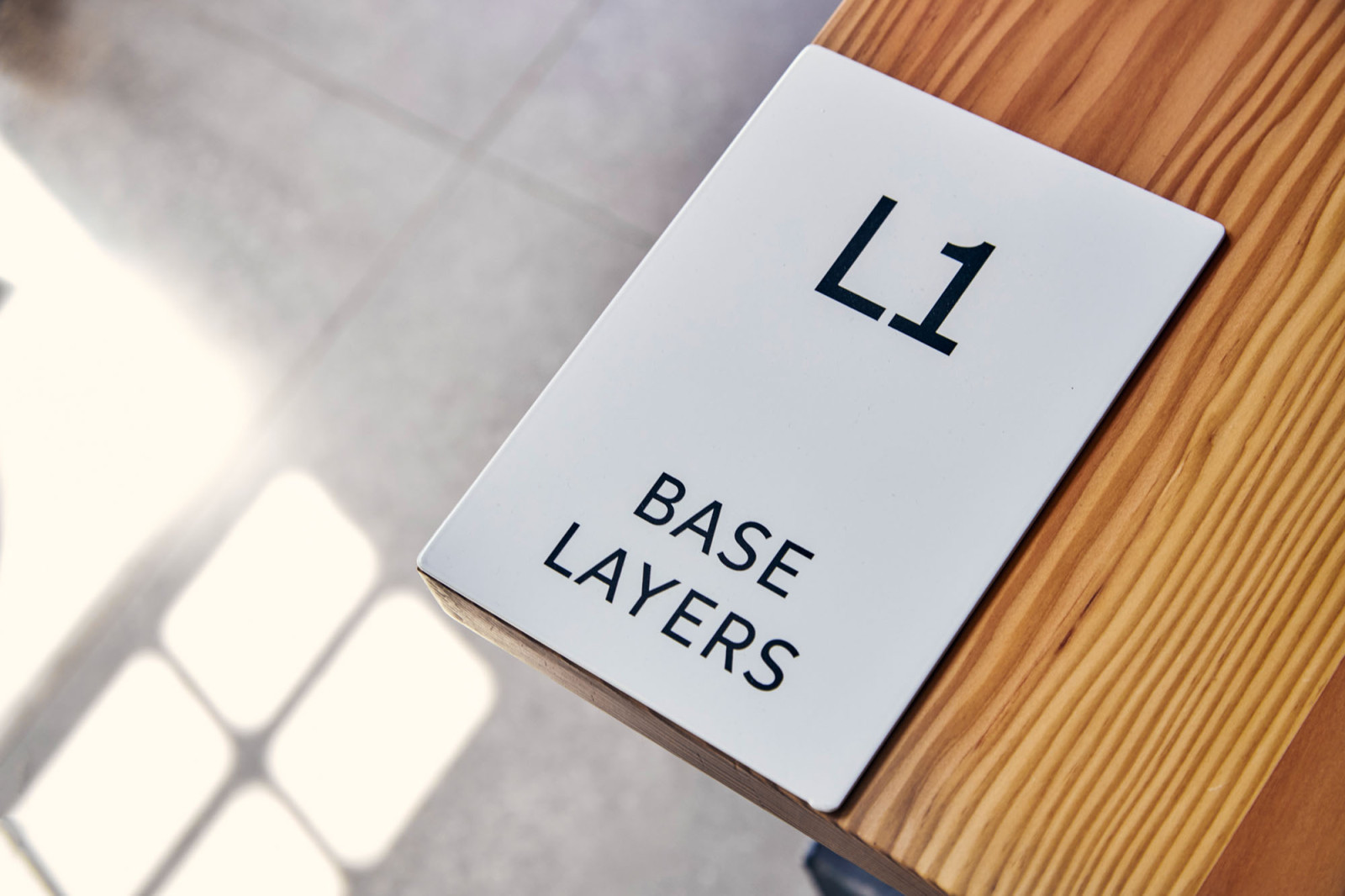 Seven Layer (7L) brand identity and signage within the store interior, designed by BusbyWebb